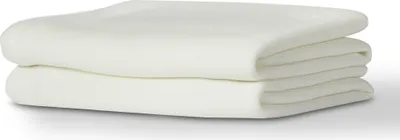 A stack of folded white sheets.