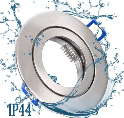 A close-up of a recessed light fixture with water splashing around it, indicating water resistance.