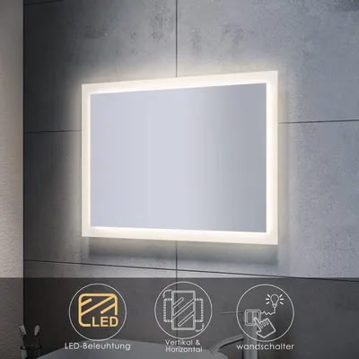 A modern bathroom mirror with integrated LED lighting, mounted on a tiled wall.
