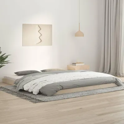 A minimalist bedroom scene with a wooden bed frame and bedding.