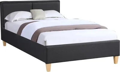 A black upholstered bed frame with white bedding and a light brown accent pillow.