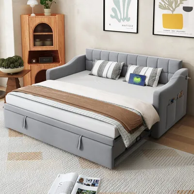 A light gray daybed sofa is shown in a living room setting, with pillows and a throw blanket.