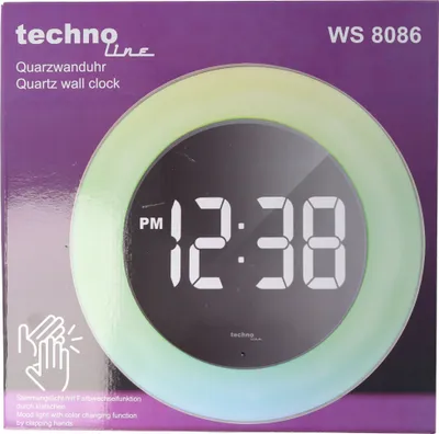 The image shows the retail packaging of a Technoline Quartz wall clock.