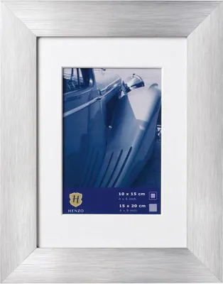A silver picture frame with a white mat, displaying a vintage car photograph.