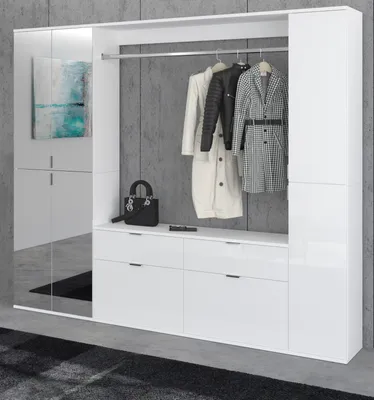 A modern white high-gloss wardrobe system with hanging clothes and a black handbag on a shelf.