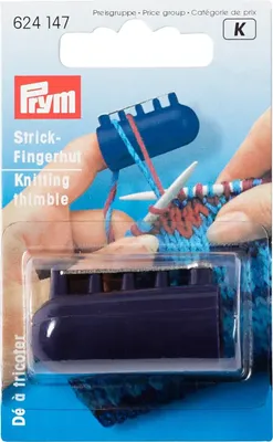 A hand is shown knitting with a blue knitting thimble on a finger.