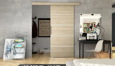 A modern bedroom with a sliding door, desk, and bed.