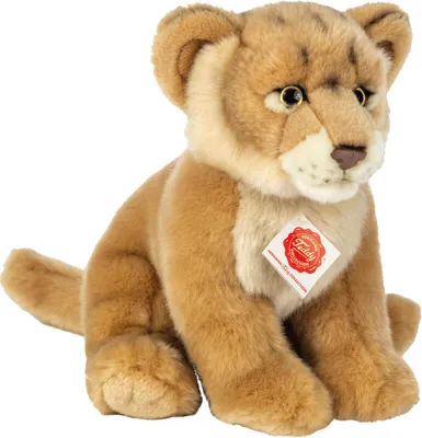 A plush toy lion cub sitting down, facing forward, with a tag attached to its chest.