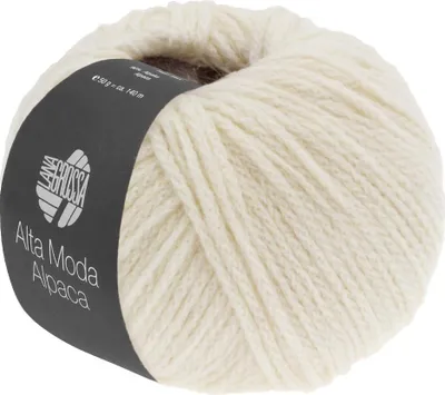 A ball of cream-colored yarn with a dark label wrapped around it.