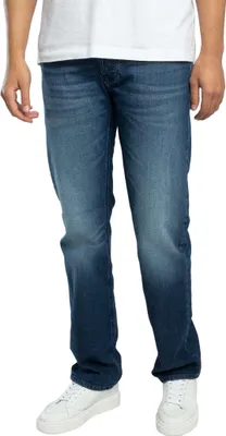 A person wearing jeans and sneakers, shown from the waist down.