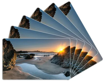 Produktbild von Wallario Frühstücksbrettchen 6er Set aus Glas, je 14 x 23 cm, mit rutschfesten Füßen, Motiv Sonnenuntergang hinter einem Felsen am Strand