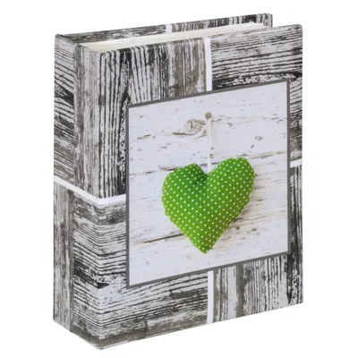 A photo album with a wooden texture design and a green heart decoration.