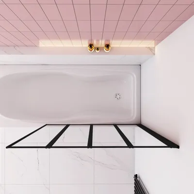 A top-down view of a modern bathroom with a white bathtub and a black framed glass shower screen.