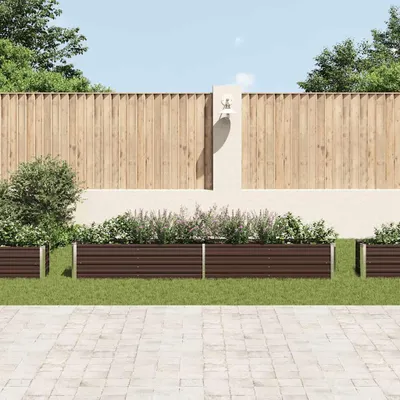 A garden scene with raised garden beds in front of a wooden fence.