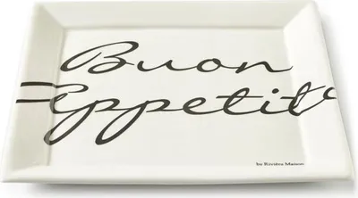 A rectangular white ceramic plate with black script text "Buon Appetito" and a small brand name at the bottom right.