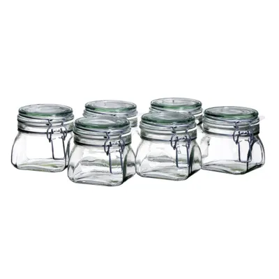 A group of six clear glass jars with silver wire bail closures and green rubber gaskets.