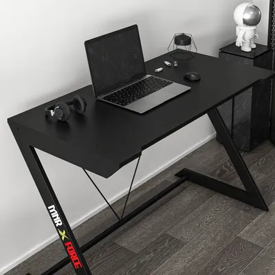 A black gaming desk with a laptop and headphones on it.