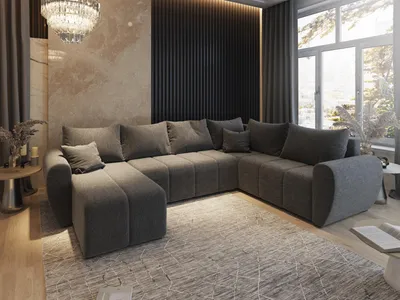 A modern living room with a large sectional sofa, a chandelier, and a large window with a view of trees.