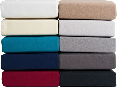 A stack of folded fabric sheets in various colors.