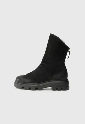 A black suede boot is shown against a light gray background.