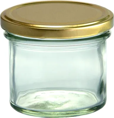 A clear glass jar with a gold lid, isolated on a white background.