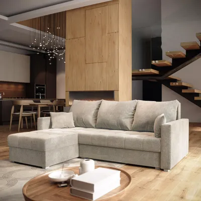 A modern living room with a sectional sofa, fireplace, and staircase.