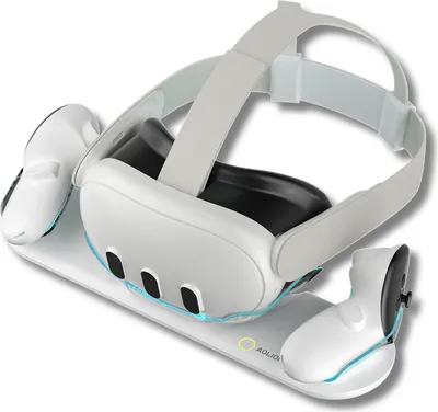 A white VR headset and controllers are placed on a white charging dock.