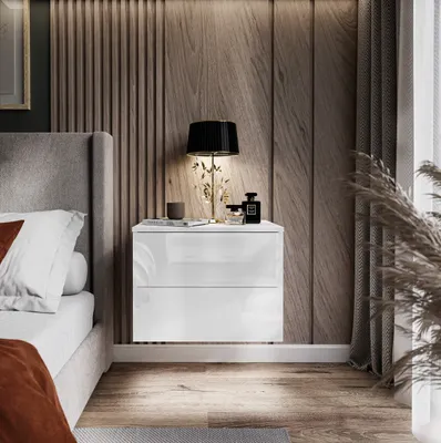 A modern bedroom scene with a bedside table next to a bed.