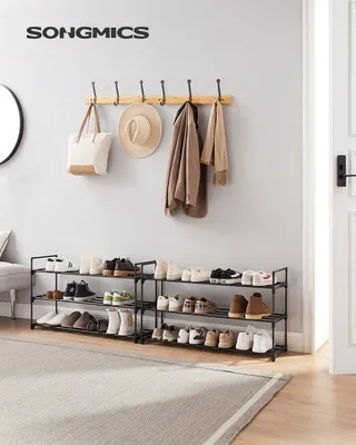 A hallway or entryway setting with shoe racks and a coat rack.