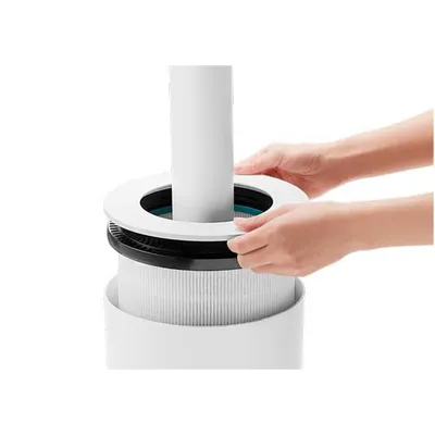 Hands assembling an air purifier filter.