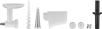 A collection of kitchen appliance attachments laid out on a white background.