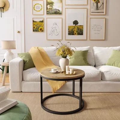 A living room scene with a couch, coffee table, and wall art.