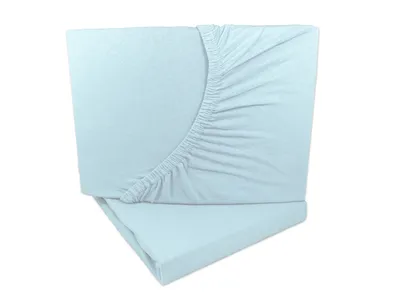 A light blue fitted sheet is folded and stacked on top of another fitted sheet.