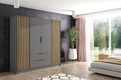 A modern bedroom with a large wardrobe, bed, and window overlooking a garden.