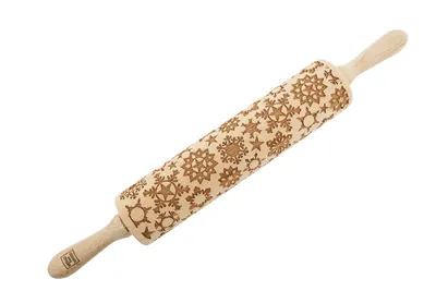 A wooden rolling pin with snowflake patterns carved into it, shown against a white background.