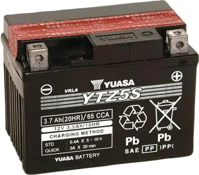 A black motorcycle battery with labels and markings.