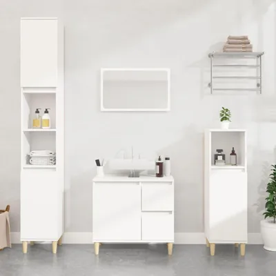 A clean, modern bathroom setup featuring white furniture and accessories against a light gray wall.