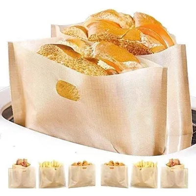 A close-up of reusable toaster bags filled with bread, with smaller bags of snacks shown below.