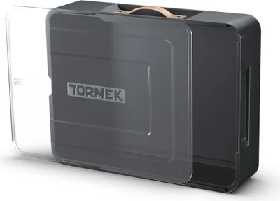 A black Tormek case with a clear sliding lid and a tan handle is shown against a white background.