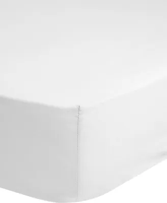 A close-up view of a white fitted sheet.
