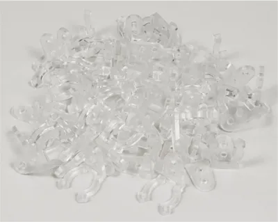 A pile of clear plastic clips on a white background.
