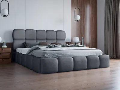 A modern bedroom with a large upholstered bed.