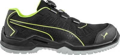 A side view of a black Puma safety shoe with neon green accents.