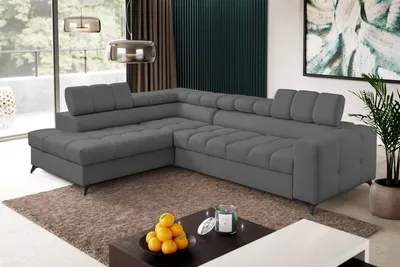A modern living room with a large sectional sofa, coffee table, and artwork.
