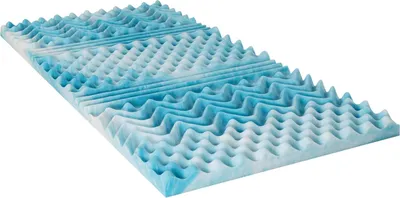 A close-up, angled view of a blue and white foam mattress topper with a convoluted surface.
