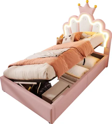 A pink princess-themed bed with a crown-shaped headboard and LED lighting, shown with its storage compartment open.