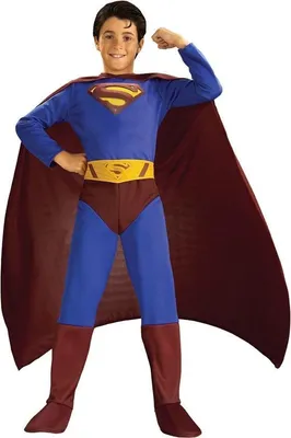 A young boy is posing in a Superman costume.