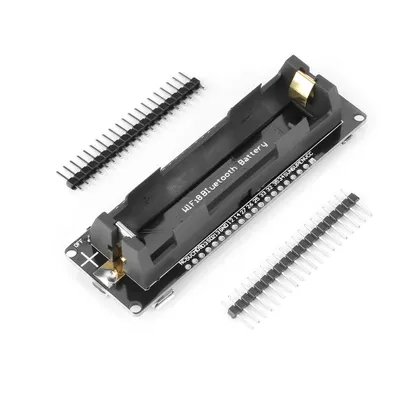 A product shot of an ESP32 development board with a battery holder and header pins.