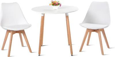 A white round table with two white chairs and a small vase of flowers on top of the table.