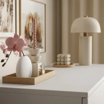 A close-up of a white dresser top with decorative items.